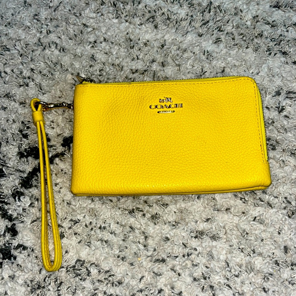 yellow coach handbag that is in pretty good quality.